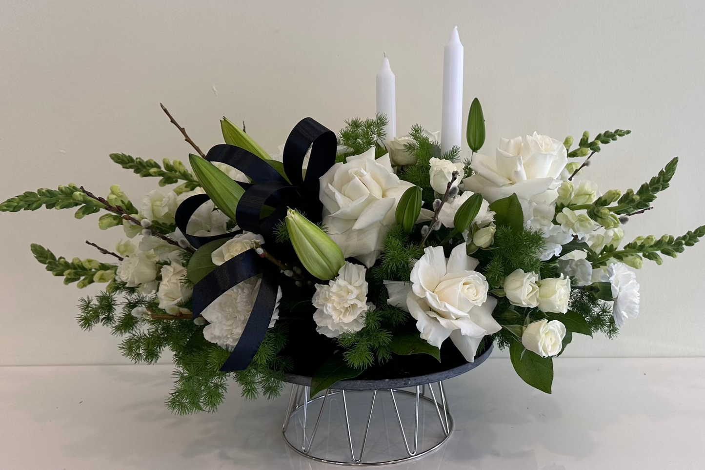 Condolence flowers with white roses and greenery in low vase โ Lotus Landโ