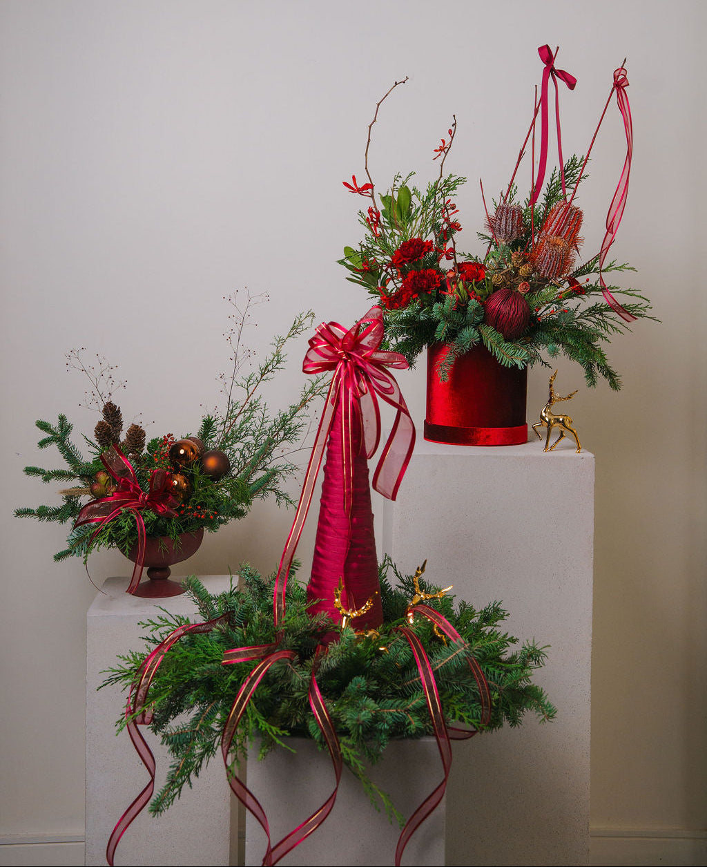 Red and green Christmas floral décor with fresh evergreens