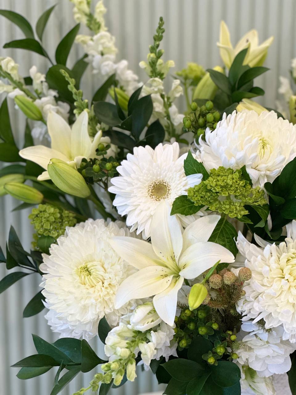 Elegant sympathy vase arrangement in white and green β handcrafted in Aurora