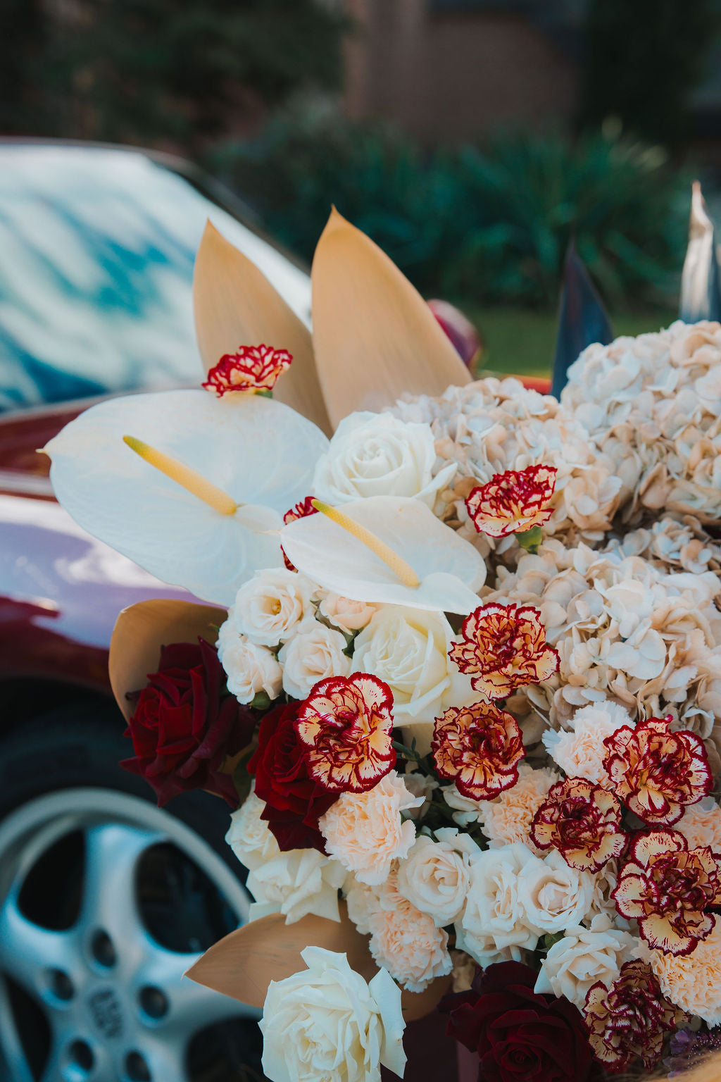 Luxury red floral arrangement in burgundy box