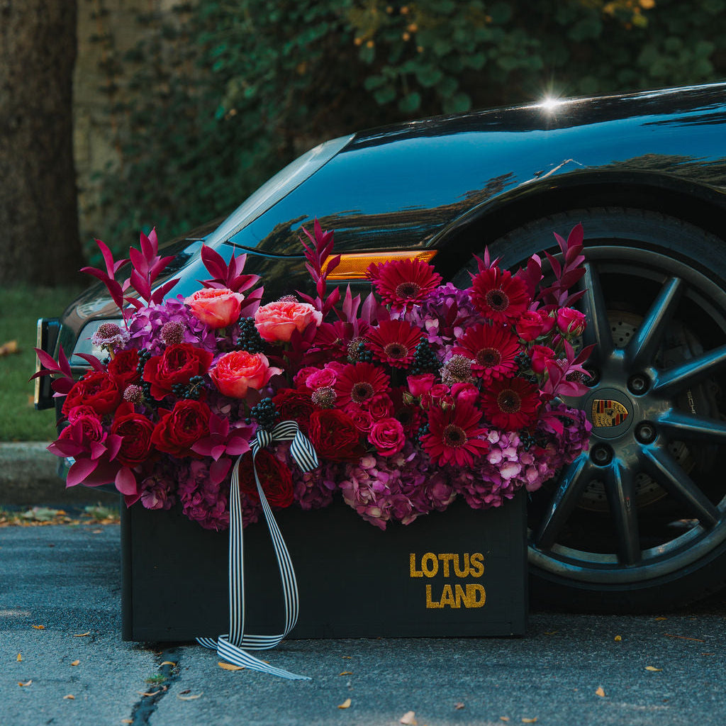 Luxury floral box arrangement in a black box with rich tones and modern elegance
