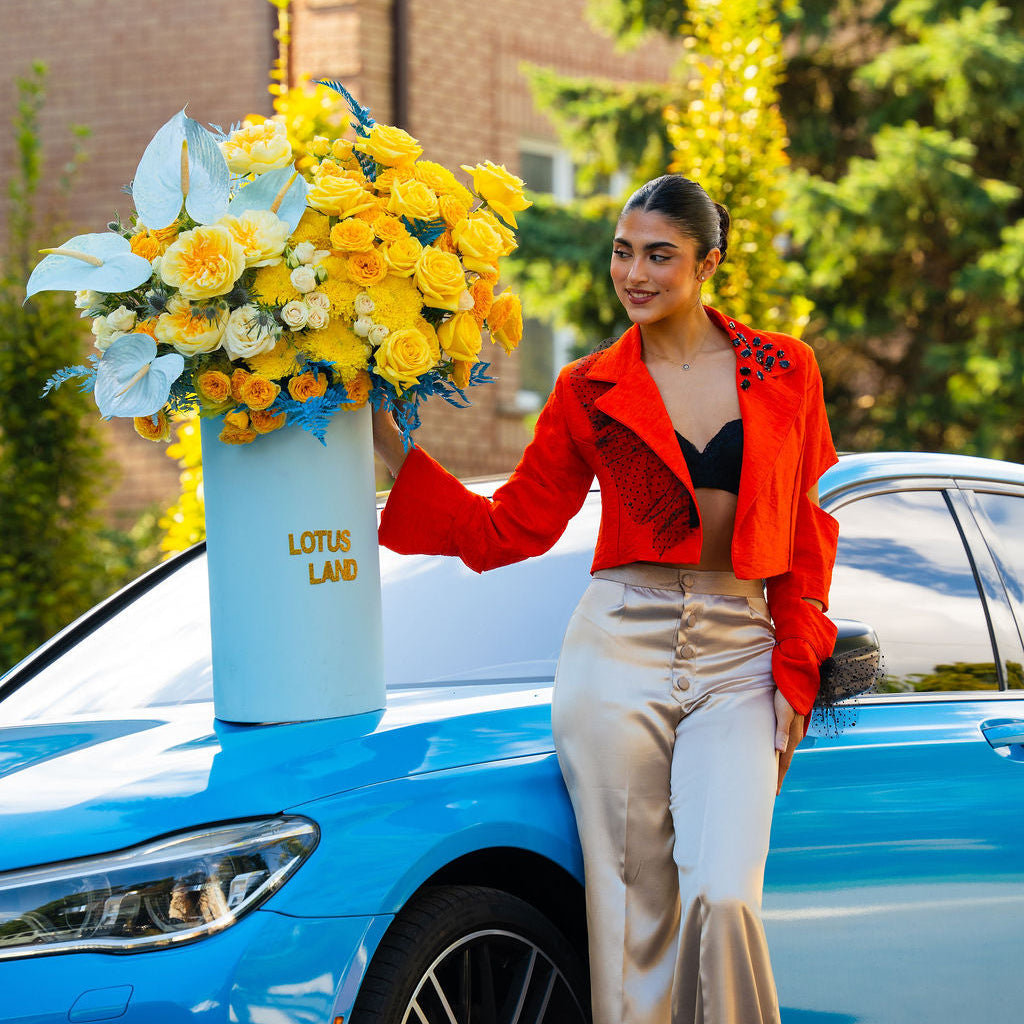 Luxury yellow floral arrangement in blue box