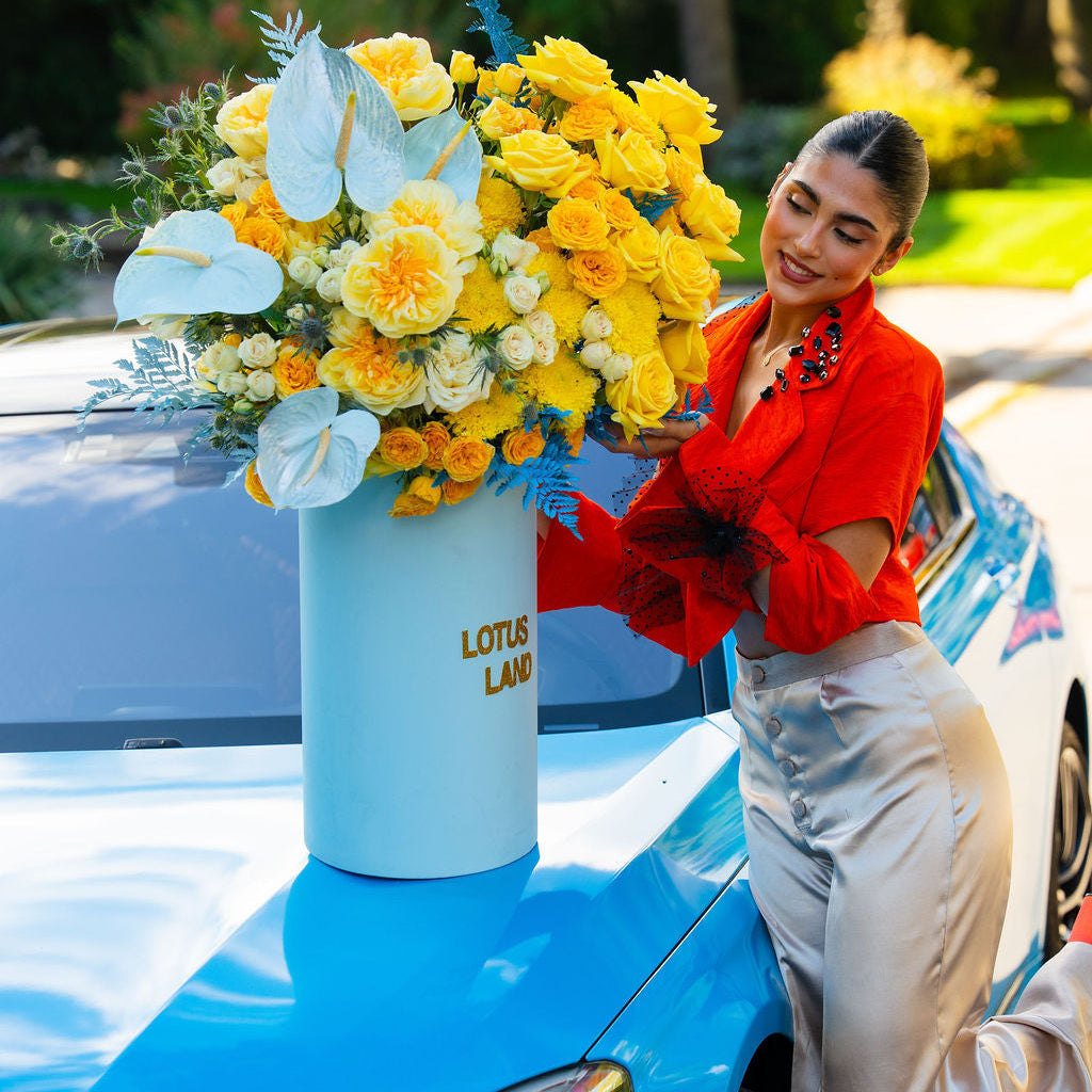 Luxury yellow floral arrangement in blue box