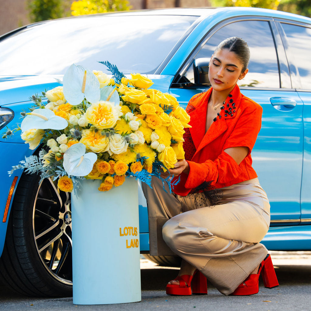 Luxury yellow floral arrangement in blue box