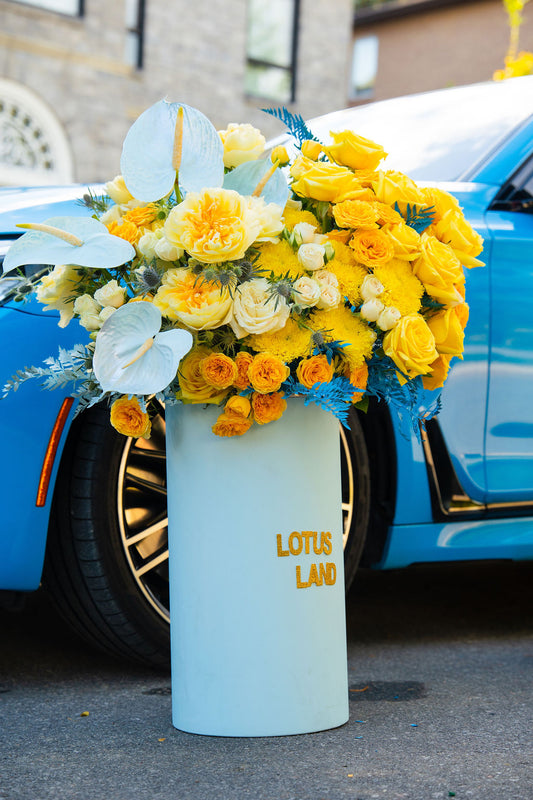 Luxury yellow floral arrangement in blue box