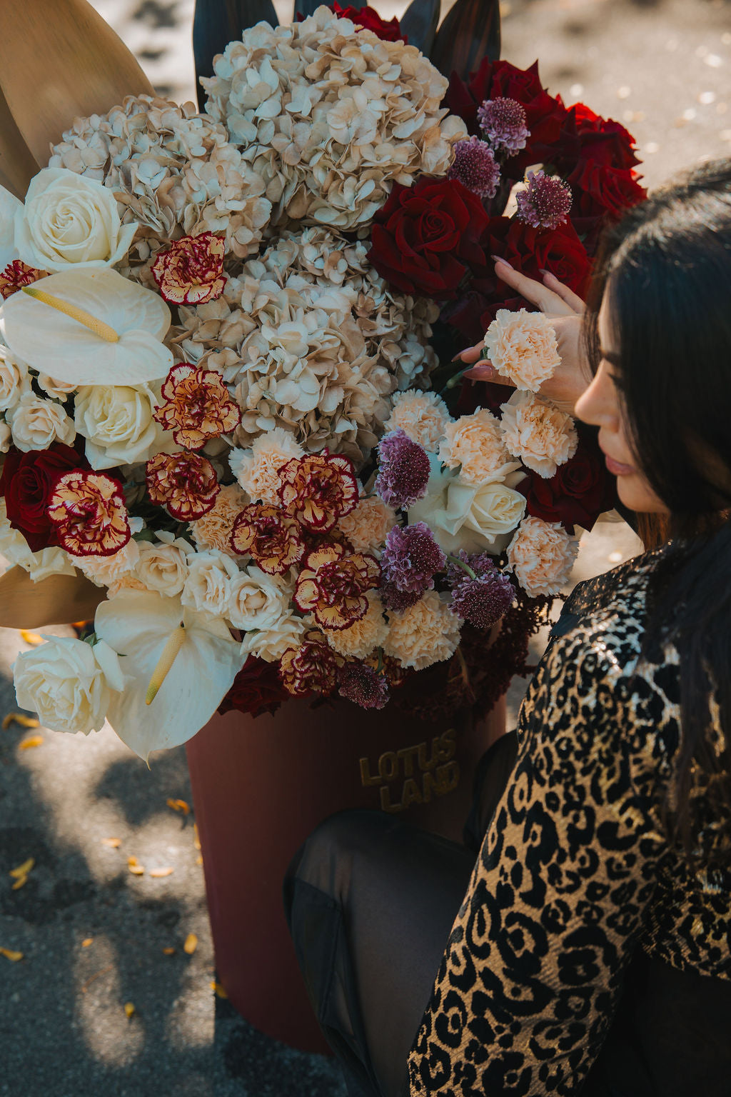 Load video: Luxury giant flower box beside a white Porsche , elegant floral design by Lotus Land Boutique
