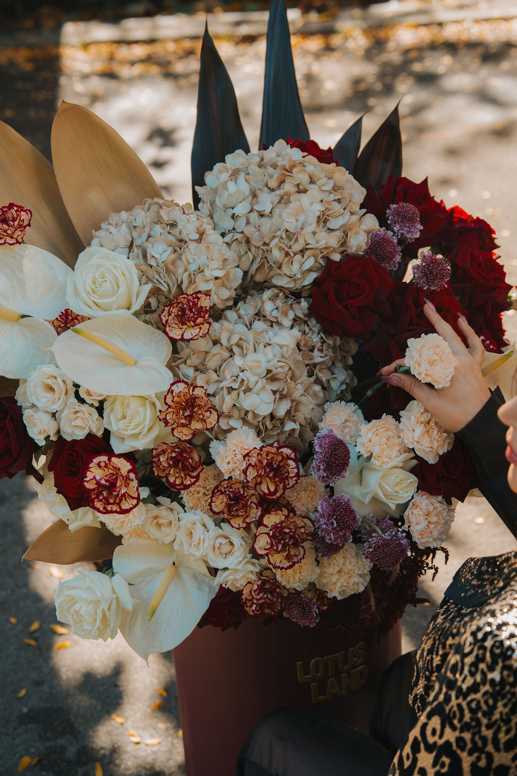 Luxury red floral arrangement in burgundy box