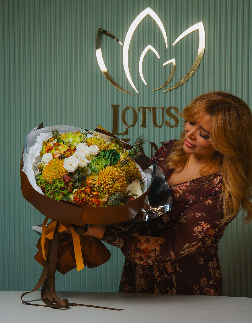 Luxury autumn bouquet with golden chrysanthemums, ivory roses, and brown wrapping by Lotus Land