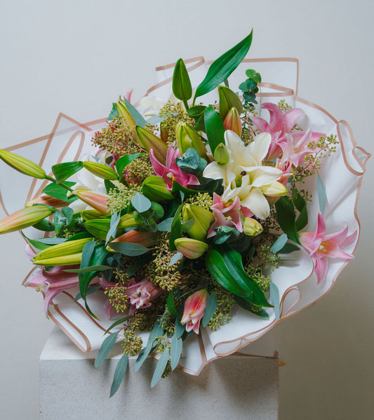 Luxury pink and white lily bouquet with eucalyptus and elegant wrapping by Lotus Land