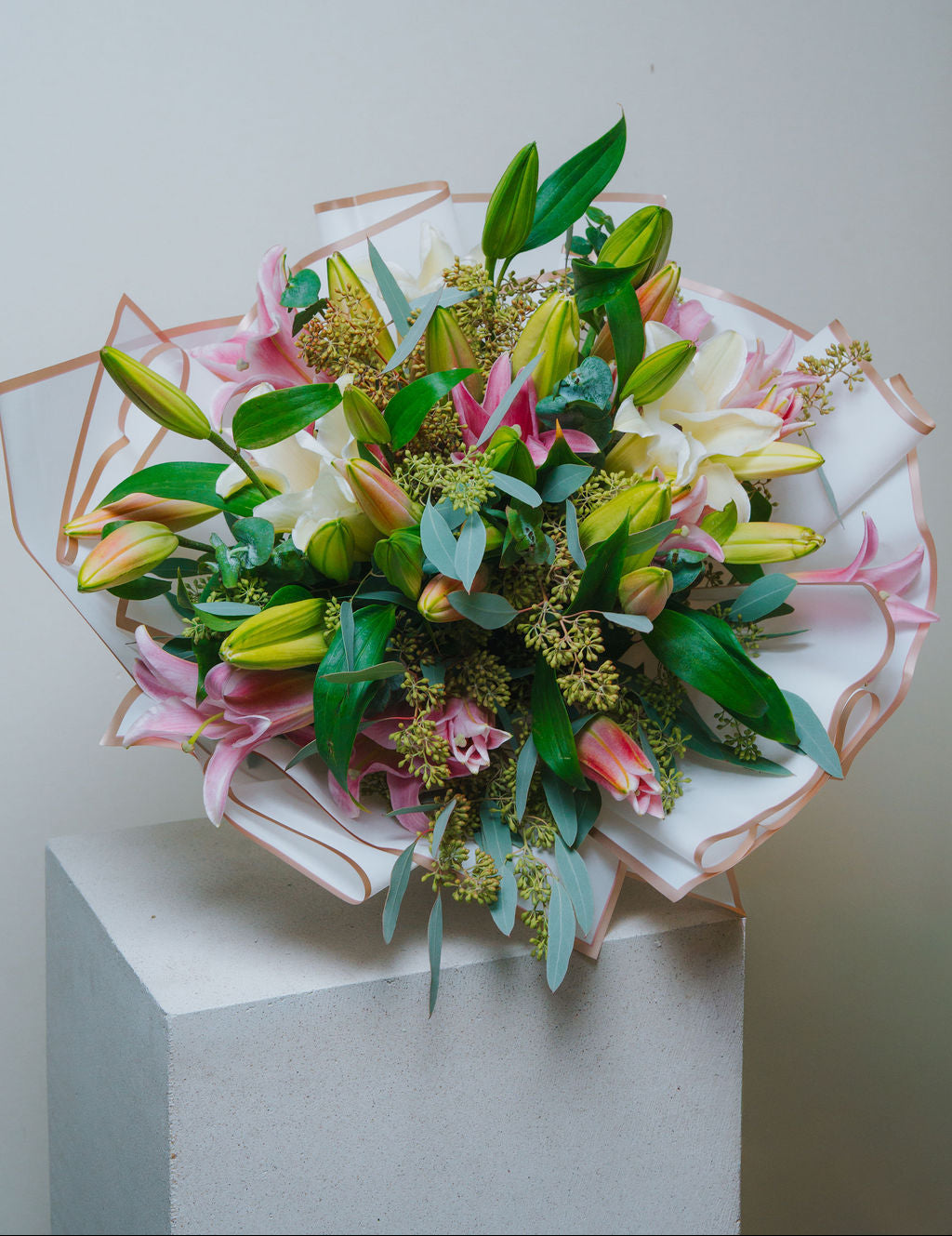 Luxury pink and white lily bouquet with eucalyptus and elegant wrapping by Lotus Land