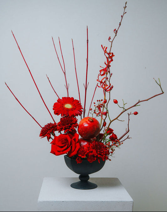 Luxury red floral arrangement in matte black vase by Lotus Land