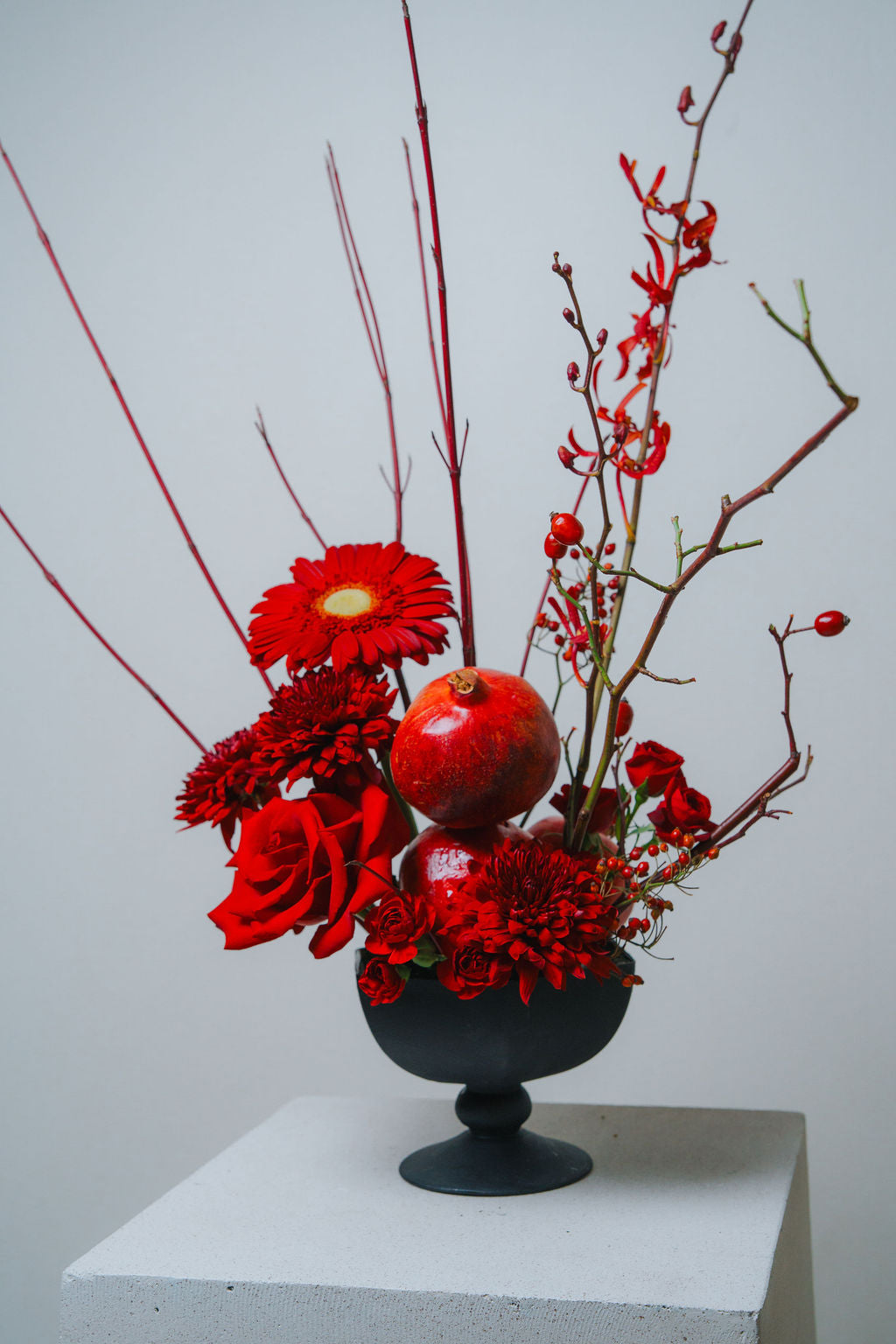 Luxury red floral arrangement in matte black vase by Lotus Land