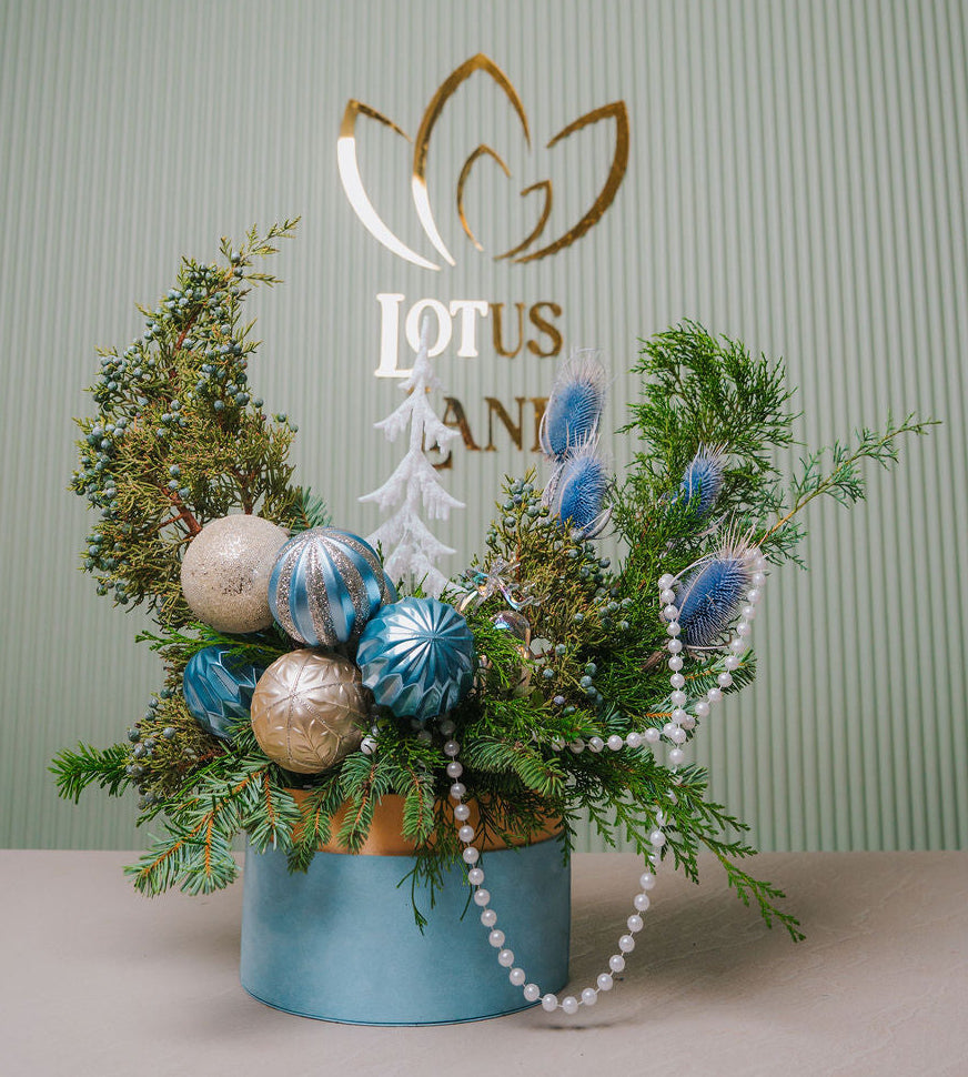 Luxury winter blue Christmas floral arrangement with evergreen and ornaments