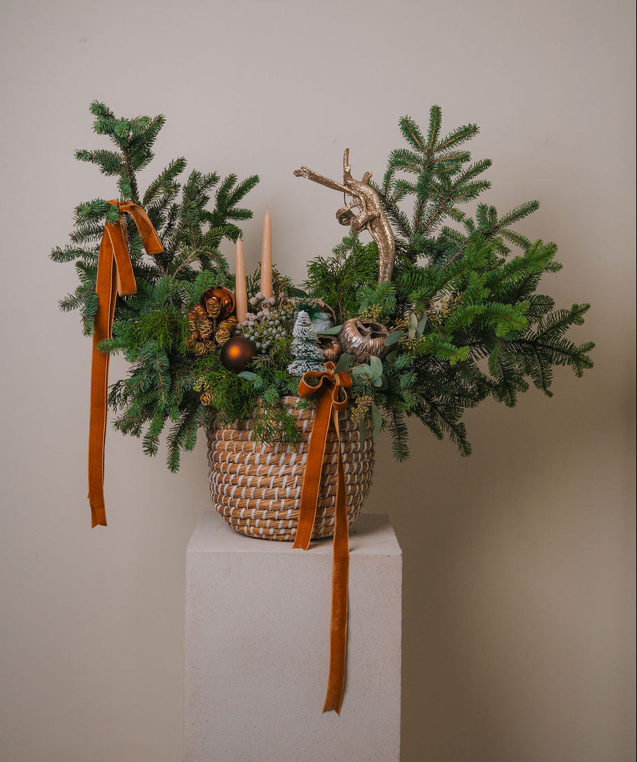 Luxury evergreen Christmas arrangement with natural greenery, golden accents, and forest-inspired design