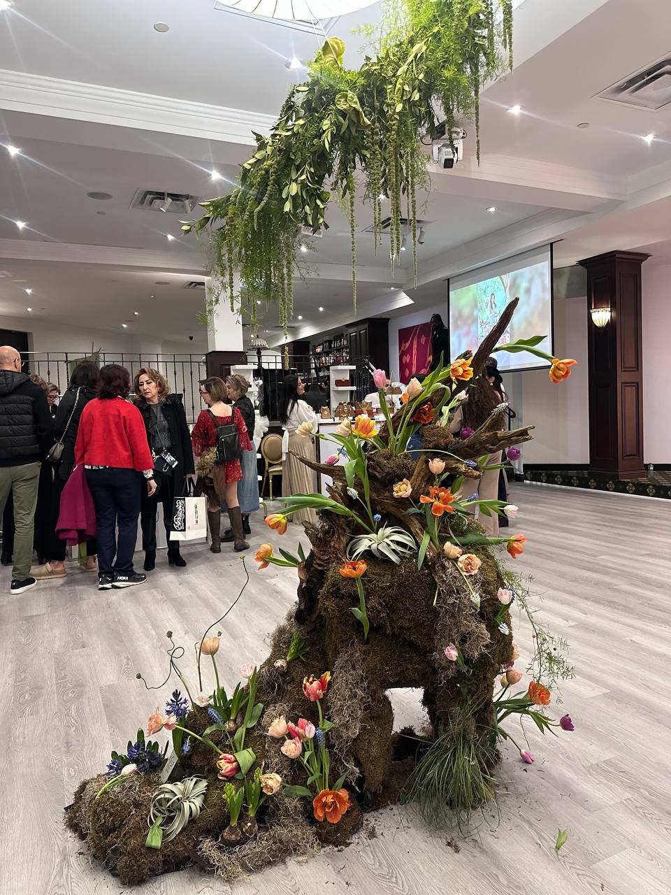 Luxury floral installation with moss, tulips, and cascading greenery at the Raavi Art Event in Toronto, designed by Lotus Land  Flower Boutique