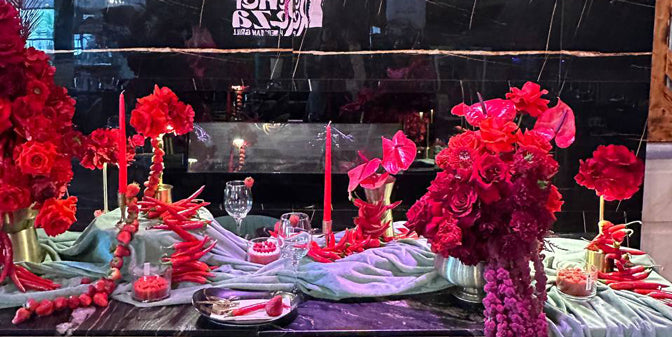 “Contemporary red floral sculpture with roses, chili peppers, and textured styling for a luxury Valentine’s Day event in Toronto
