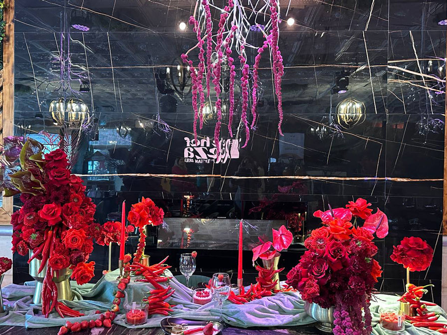 Luxury red floral arrangement with roses, chili accents, and modern table styling for Chef Reza’s Valentine’s Day event in Toronto