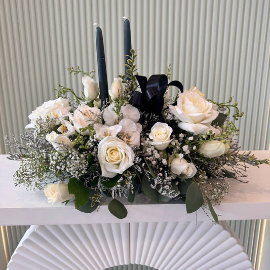 White rose sympathy flower arrangement with black candles – Aurora funeral delivery