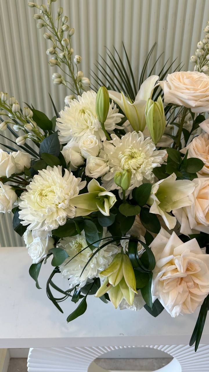 "Elegant white lilies, roses, and greenery in a textured vase – Lotus Land Shop"